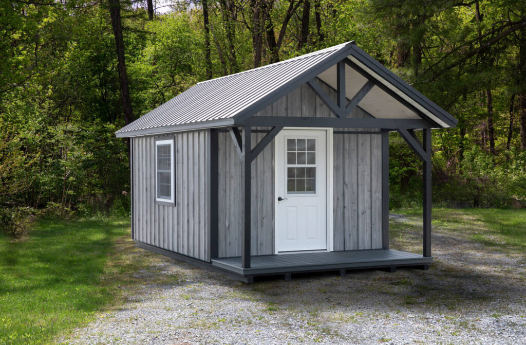 small 10x18 cabin by dwellity with gray siding and metal roof