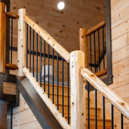 log hand railing with round iron banisters